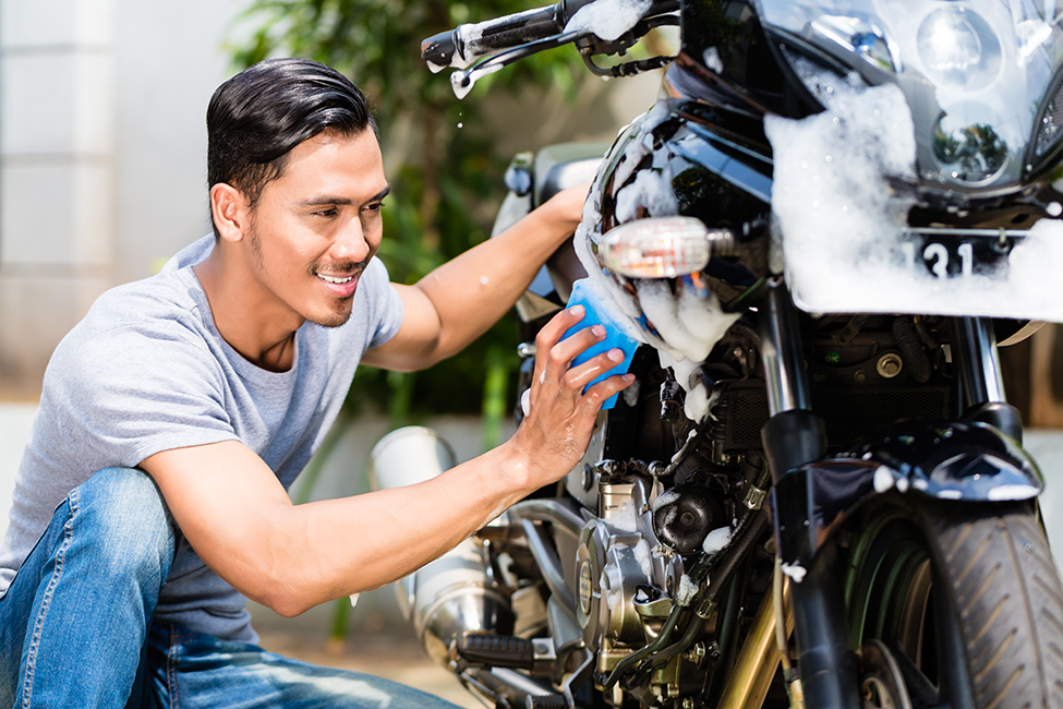 How should you wash your motorbike or scooter?